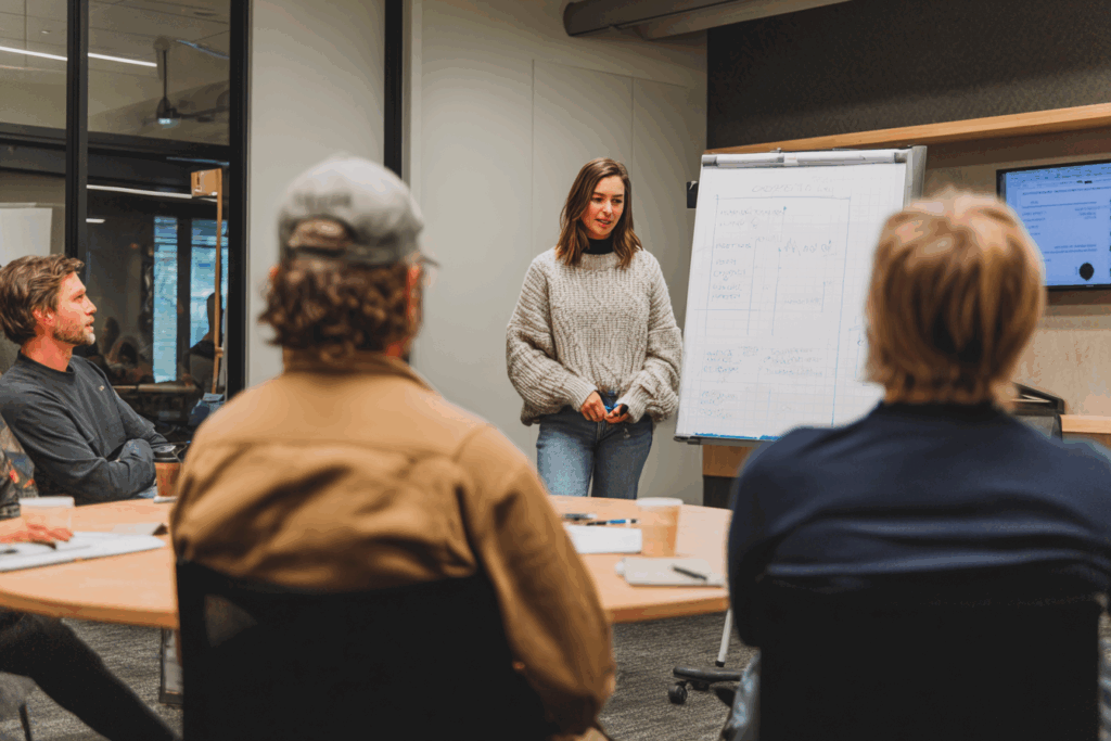 Trainer leading a short Teams session with a small group in a meeting room